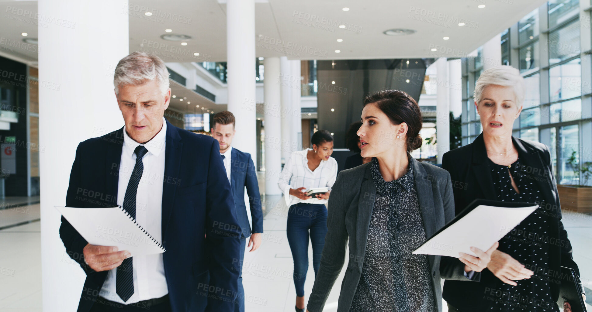Buy stock photo Office, walking and group with documents, talking and preparation for speech, politics and serious. Corporate, reading and chancellor with team for meeting, colleagues and people with paperwork