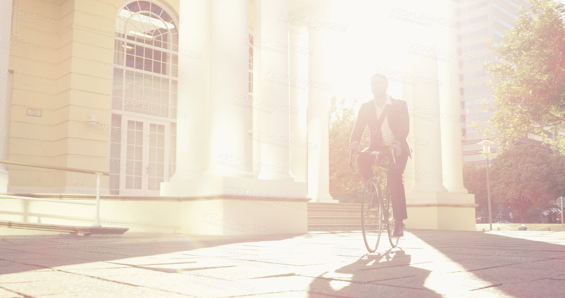 Buy stock photo Travel, bicycle and businessman in city building, reduce traffic and eco friendly transportation. Bike, urban commute and male corporate employee cycling to work for carbon footprint in sunshine