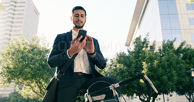 Buy stock photo Business, man and typing with phone in city for real estate, showcase viewing and morning commute. Below, male agent and mobile app on bicycle with commercial property,  navigation map of negotiation