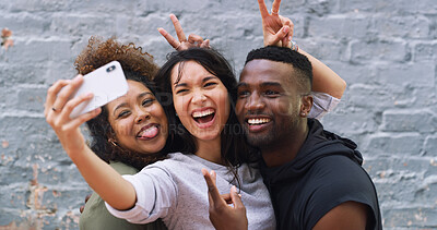 Buy stock photo Selfie, funny and group of people by wall in city for memory, social media or profile picture on holiday. Happy, goofy and young friends with photography for reunion content creation vlog in town.