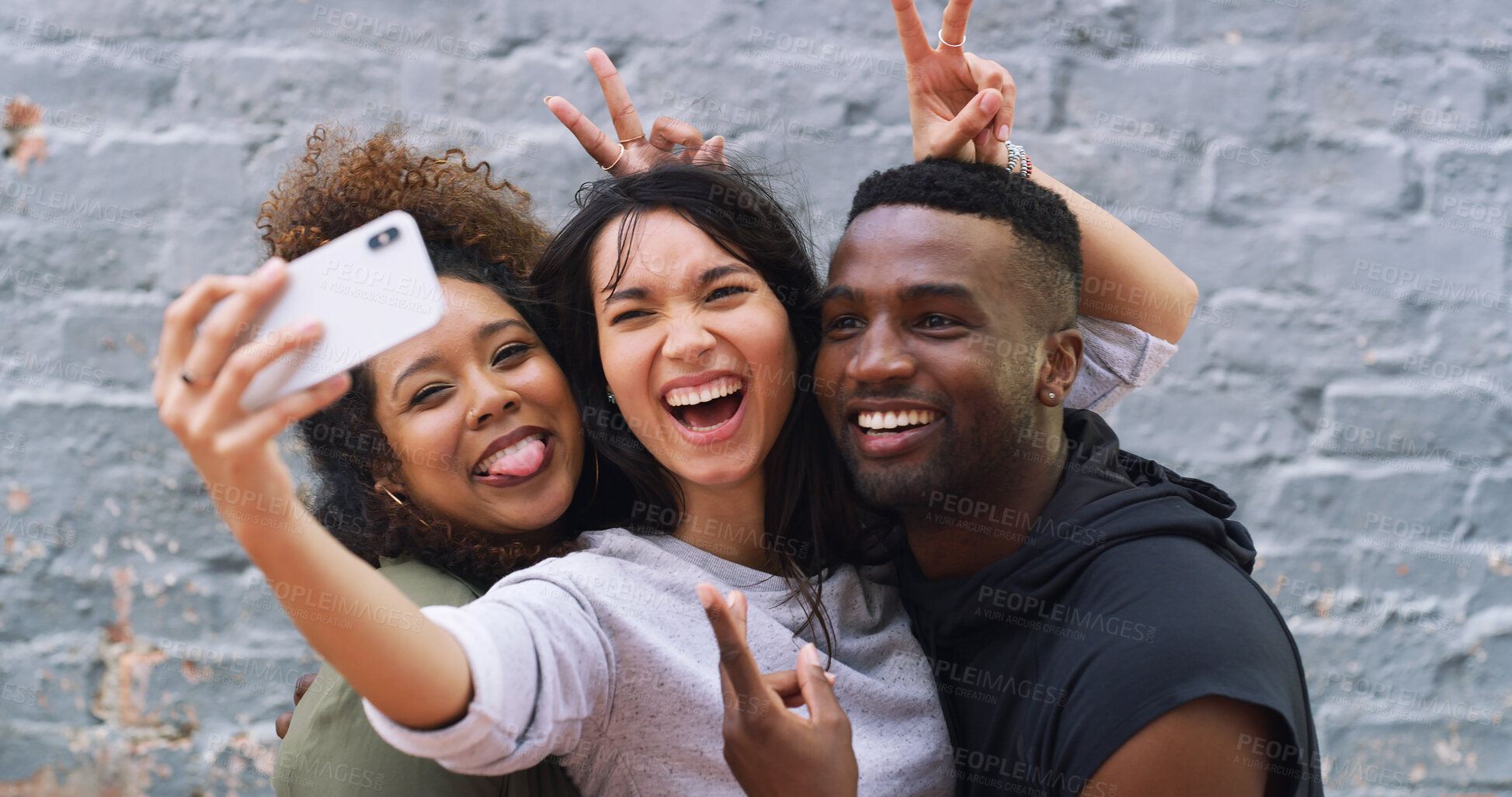 Buy stock photo Selfie, funny and group of people by wall in city for memory, social media or profile picture on holiday. Happy, goofy and young friends with photography for reunion content creation vlog in town.