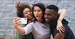 Selfie, funny and group of friends by wall in city for memory, social media or profile picture on holiday. Happy, goofy and young people with photography picture for content creation vlog in town.