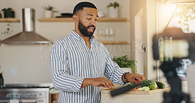 Buy stock photo Camera, live streaming and man for cooking tutorial, cuisine and meal preparation in home kitchen. Culinary influencer, content creator and person with food, recipe or ingredients for social media