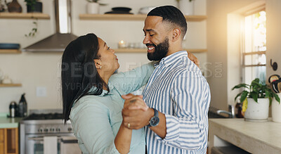 Buy stock photo Couple, holding hands and dancing in home, talking and bonding on valentines day. Happy people, commitment and together for connection in kitchen, romance and comfortable date to sound of music