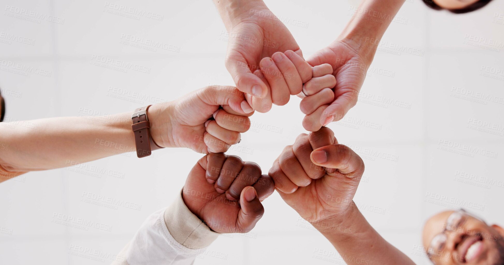 Buy stock photo Below, hands and people with fist bump for teamwork, creative collaboration and diversity in office. Design group, circle and hand gesture in agency for support, solidarity and synergy in workplace