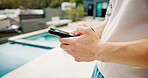Man, hands or outdoor with mobile for social media, travel planning or contact at hotel. Influencer, phone or typing at resort pool for status update, accommodation review or writing blog on platform