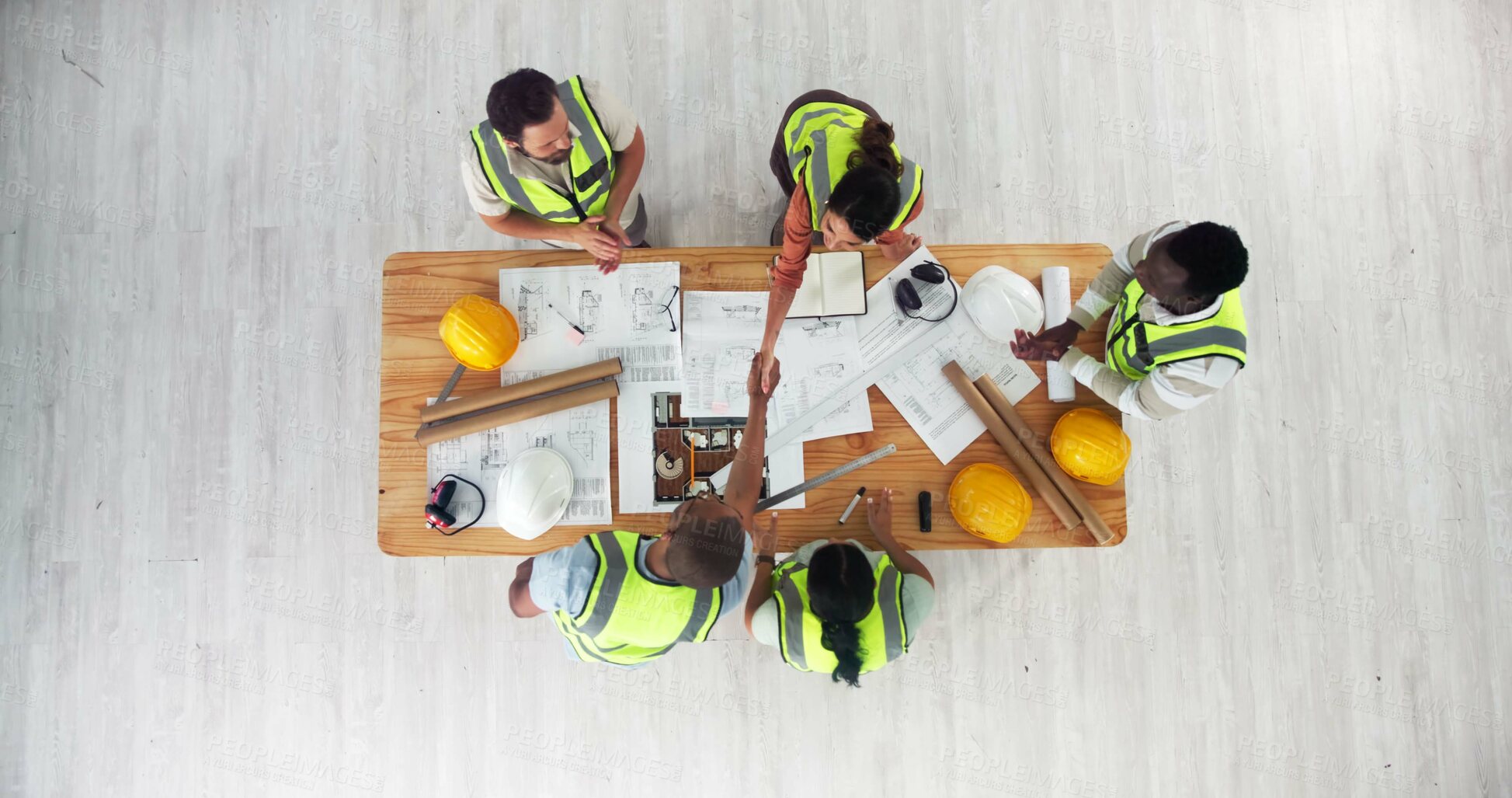 Buy stock photo Above, architecture and people with handshake for teamwork, building design and contract at space. Engineers, partnership deal or blueprint in office for investment, urban development or construction