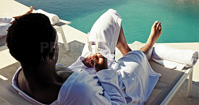 Buy stock photo Champagne, relax and luxury with black man at pool for hospitality, travel and summer vacation. Wine glass, holiday resort and hotel villa with back of person at lodge for spa, celebration and peace