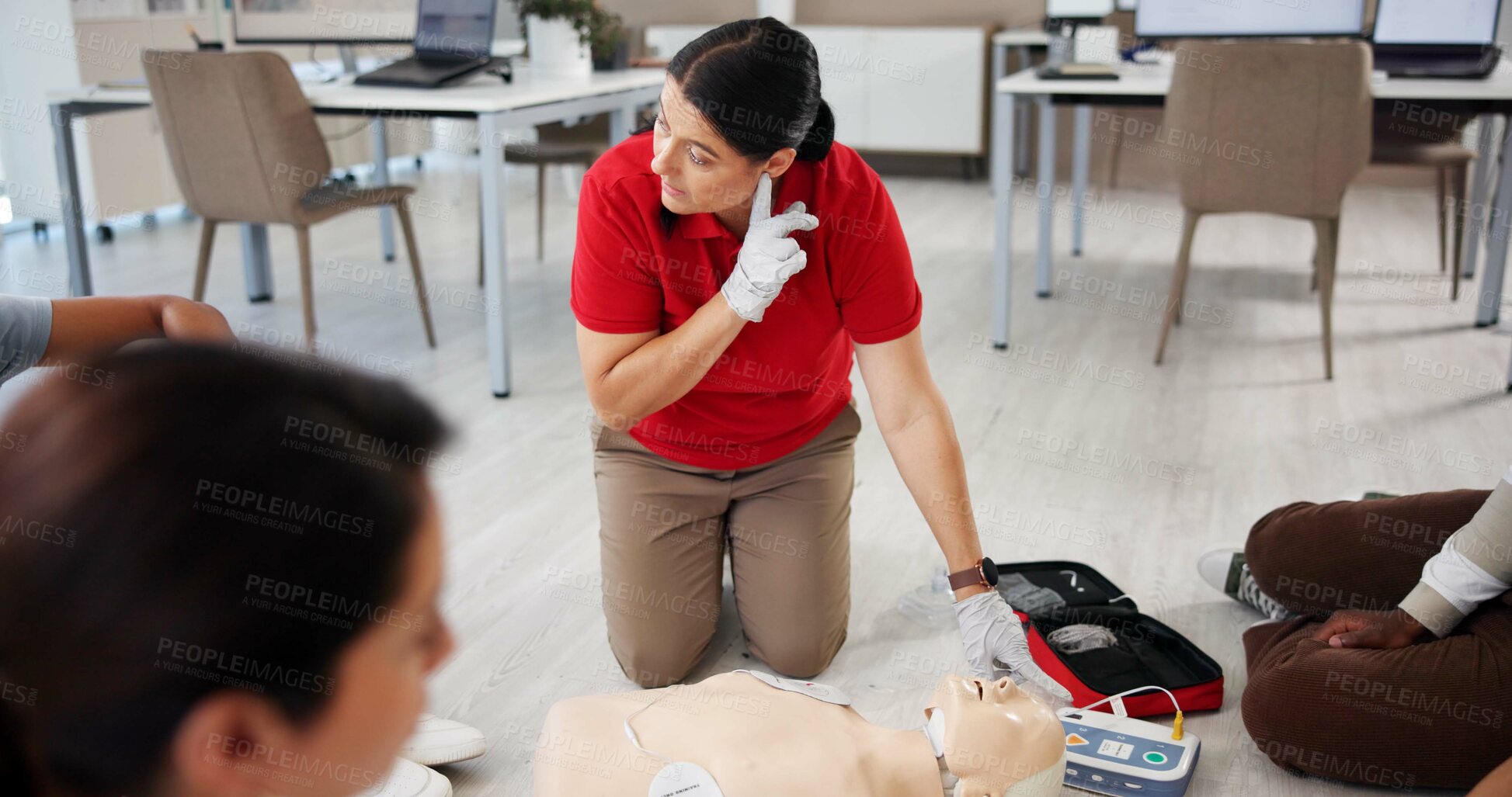 Buy stock photo Mannequin, first aid and teaching with people and defibrillator for workshop, cardiac arrest or safety protocol. Healthcare, medical simulation and heart rhythm rescue with paramedic course in office