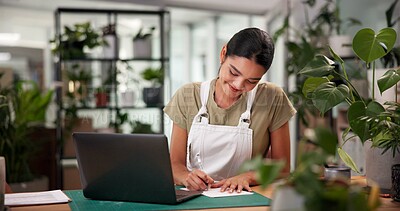 Buy stock photo Laptop, online order and writing with woman in plant nursery for sale of floral arrangements. Computer, documents and flower shop with happy florist at desk in office of small business for delivery