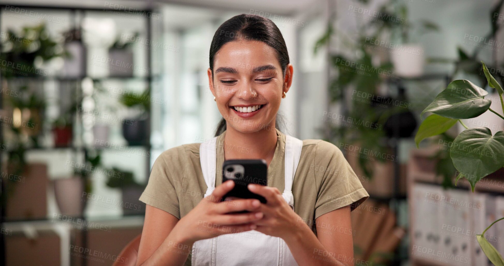 Buy stock photo Cellphone, woman and florist in store for order review with small business at startup flower shop. Happy, phone and female botanist on mobile app for floral biology research in retail plant nursery.
