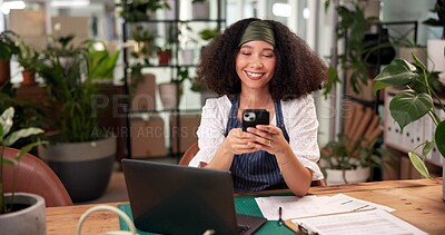 Buy stock photo Laptop, phone and smile with woman in flower shop for online order or sale of floral decor. App, text message and plant nursery with happy florist at office desk in small business for communication