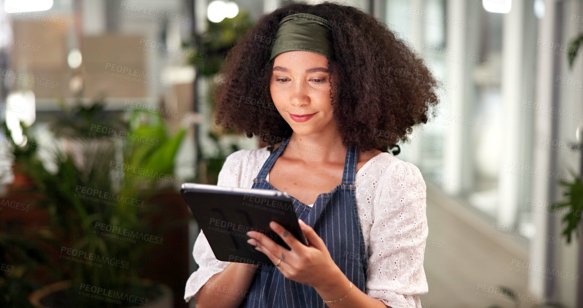 Buy stock photo Woman, florist and typing on tablet for small business reviews, plants inventory and ecommerce order. Female person, digital app and flower research of floral nursery, supply chain and stock delivery