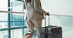 Business woman, legs and walking with suitcase for travel, commute or corporate trip at airport. Female person, building or traveler with luggage for flight departure, new career or job opportunity 