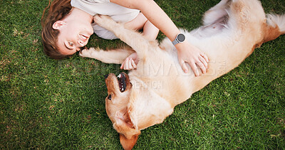 Buy stock photo Happy woman, relax and lying with dog above on grass field for bonding, love and support at park. Top view, female person or pet owner with labrador, golden retriever or playful companion in nature
