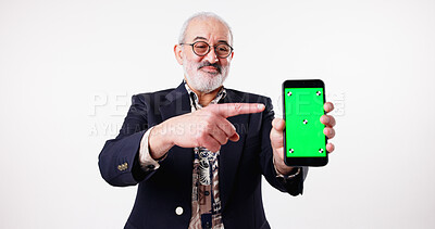 Buy stock photo Studio, green screen and mature man with smartphone, space or pointing for presentation of mobile. White background, tips and advertising of web application, tracking markers or display of technology