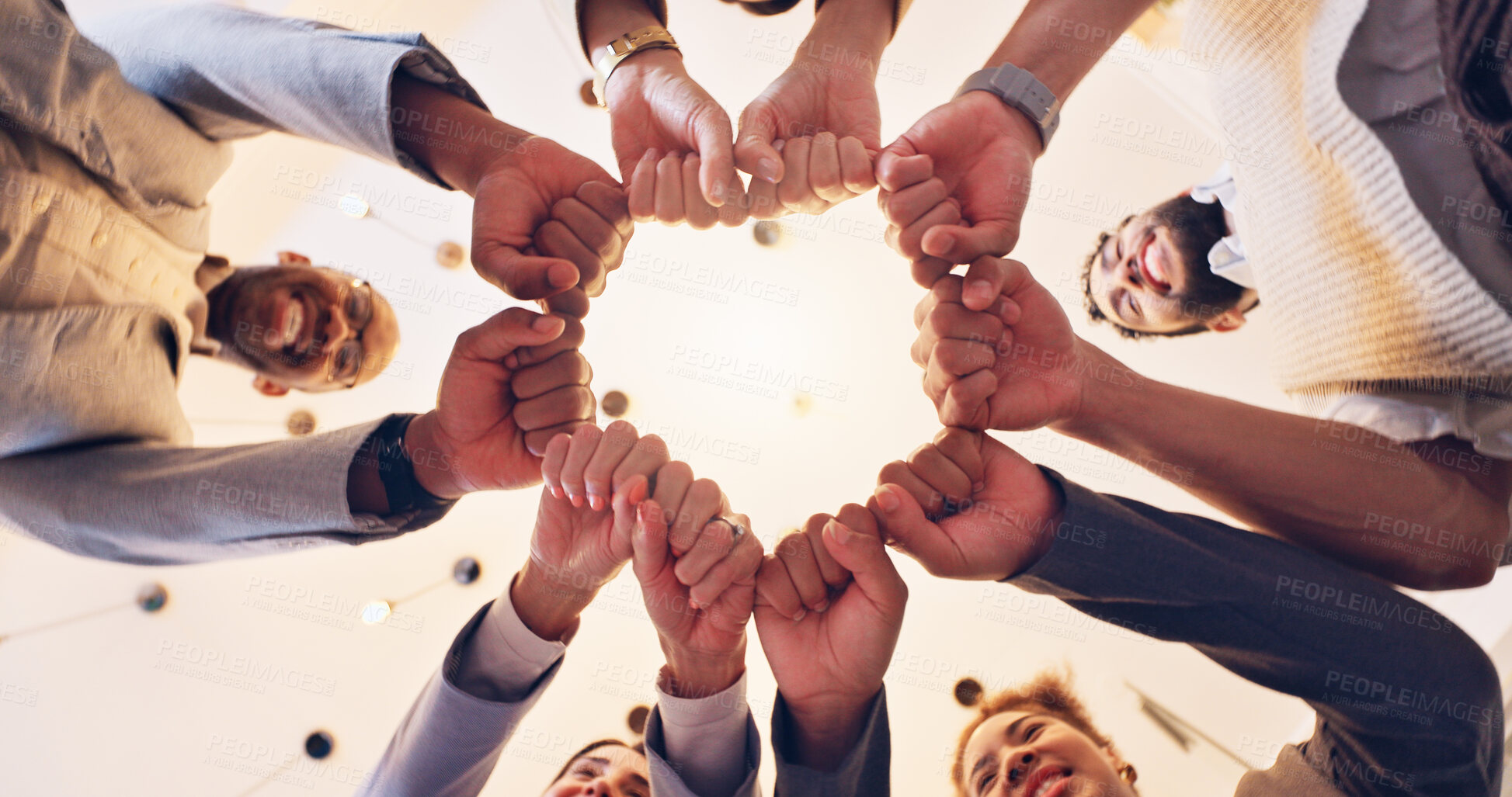 Buy stock photo Happy, business people or meeting with fist bump below for unity, motivation or teamwork at office. Low angle, employee or group with touch, smile or trust for mission, synergy or solidarity together