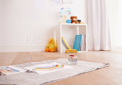 Buy stock photo Shot of children's painting supplies on the floor of a child's bedroom