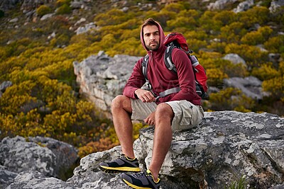 Buy stock photo Man, mountain and hiking in nature for rest and fitness for wellness and exercise for training and adventure in environment. Young person, sitting with backpack on rock for workout and trekking