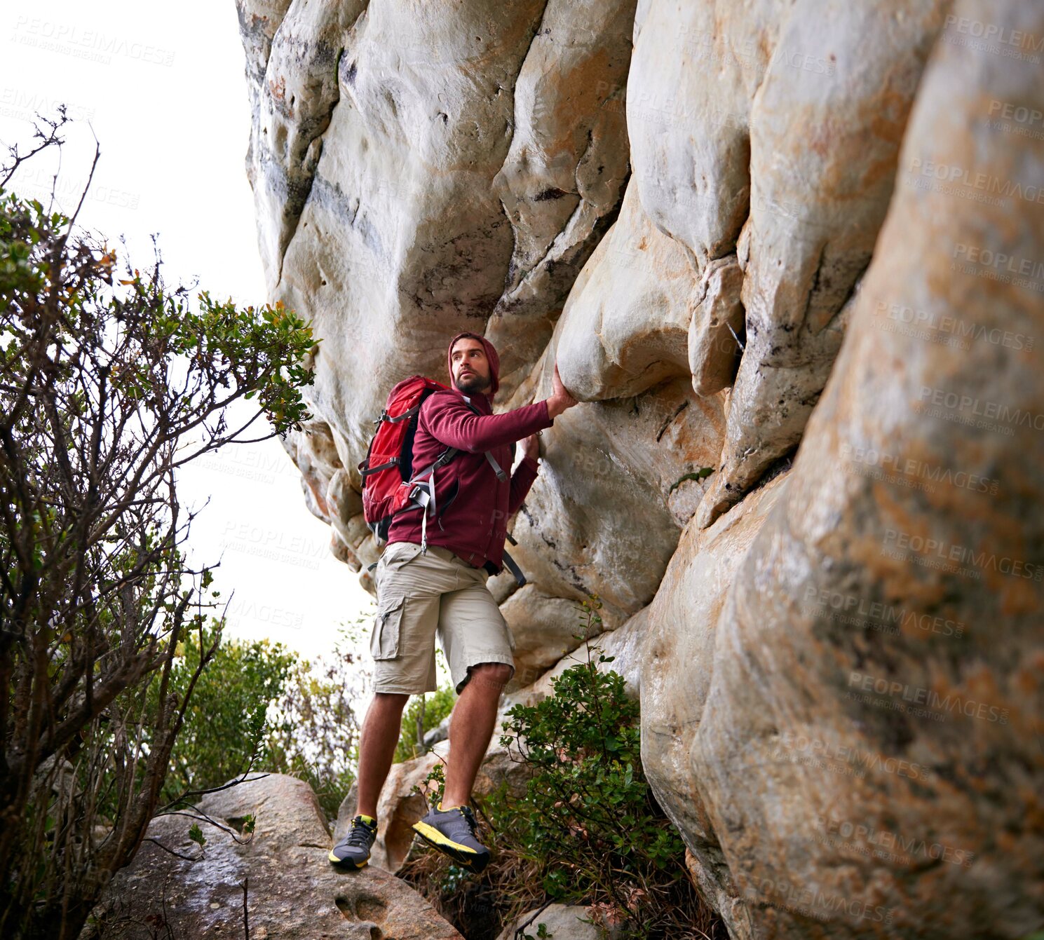 Buy stock photo Man, mountain climbing and exercise for travel outdoor, freedom and journey with adventure, focus and strong. Determination, concentration and trekking with challenge, peak and rocks on rough terrain