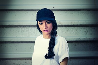 Buy stock photo Garage, portrait and woman in city with fashion, cap or gender neutral clothes for upcycling, street style or inspiration. Streetwear, face or gen z girl in New York for y2k, sale or thrifting choice