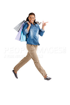 Buy stock photo Jumping, portrait and shopping with woman customer in studio for buying, consumerism or spending money. Bargain, energy and sale with excited person isolated on white background for deal or purchase