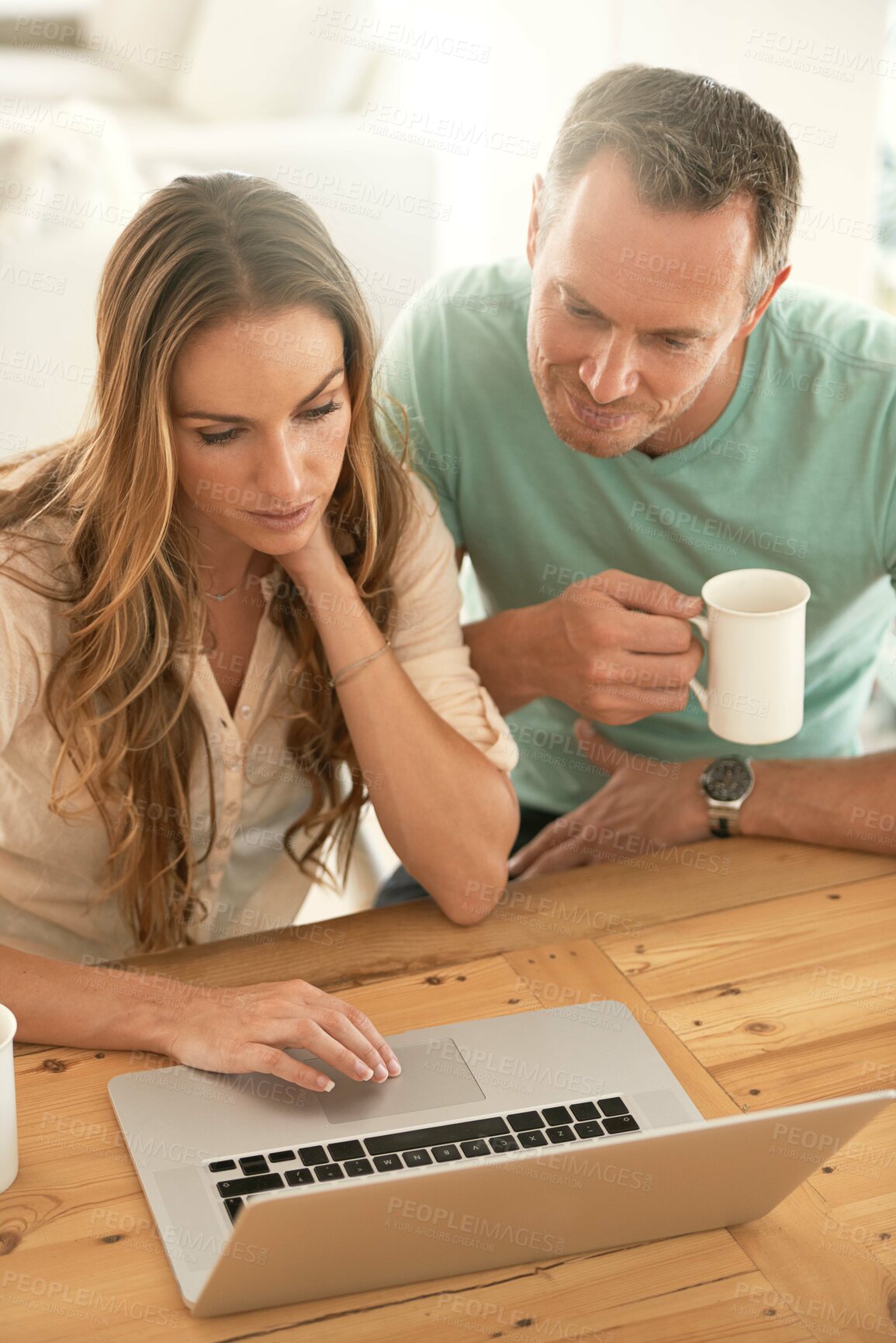 Buy stock photo Laptop, home planning and couple reading or scroll on internet together for online, website or application at table. Mature partner, woman or people on computer or pc, coffee or tea in the morning