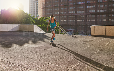 Buy stock photo Skateboard, sports and girl in city for skating stunt, practice and energy for fitness in skate park. Woman, skater and female person in urban town for outdoor talent, skill competition and hobby
