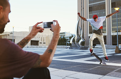 Buy stock photo Man, skateboard and picture with camera in city for trick, content creation or vlog in an urban town. Male person, photographer and capture with phone at skate park for flip stunt or online post