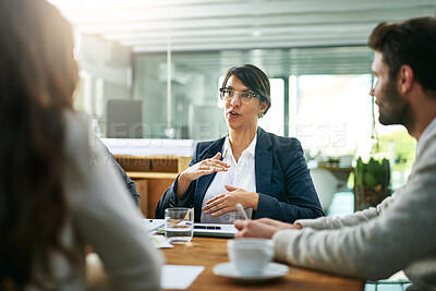 Buy stock photo Explain, talking or businesswoman in meeting for planning, collaboration or teamwork with people at office. Group, speaking or consultant with strategy for discussion, conversation or feedback review