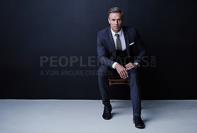 Buy stock photo Mature, businessman and portrait with fashion in studio for corporate style on a dark background. Man, professional or executive model with formal attire for business wear on chair or mockup space