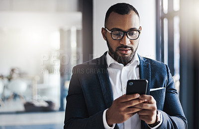 Buy stock photo Mobile, serious and business man in office for investment update, revenue and typing email. African person, phone and corporate communication on app for schedule, profit or reading financial news