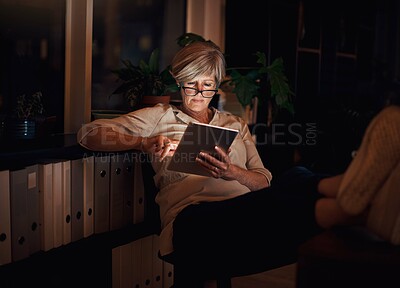 Buy stock photo Online, tablet and mature woman at desk with relax for notification, reading proposal or review. Business, night and happy person with glasses for information, email or news article in home office