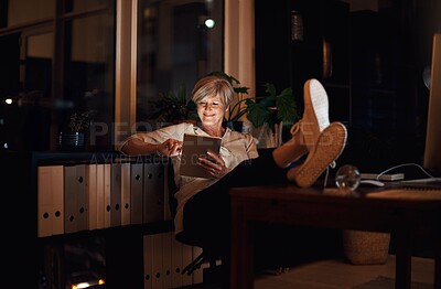 Buy stock photo Night, tablet and mature woman at desk with relax for notification, reading proposal or review. Business, online and happy person with tech for information, email or news article in home office