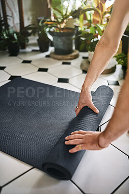 Buy stock photo Man, hands and rolling pilates mat in home, prepare equipment and ready for spiritual fitness. Person, practice routine and living room floor for meditation exercise, yoga and start in apartment