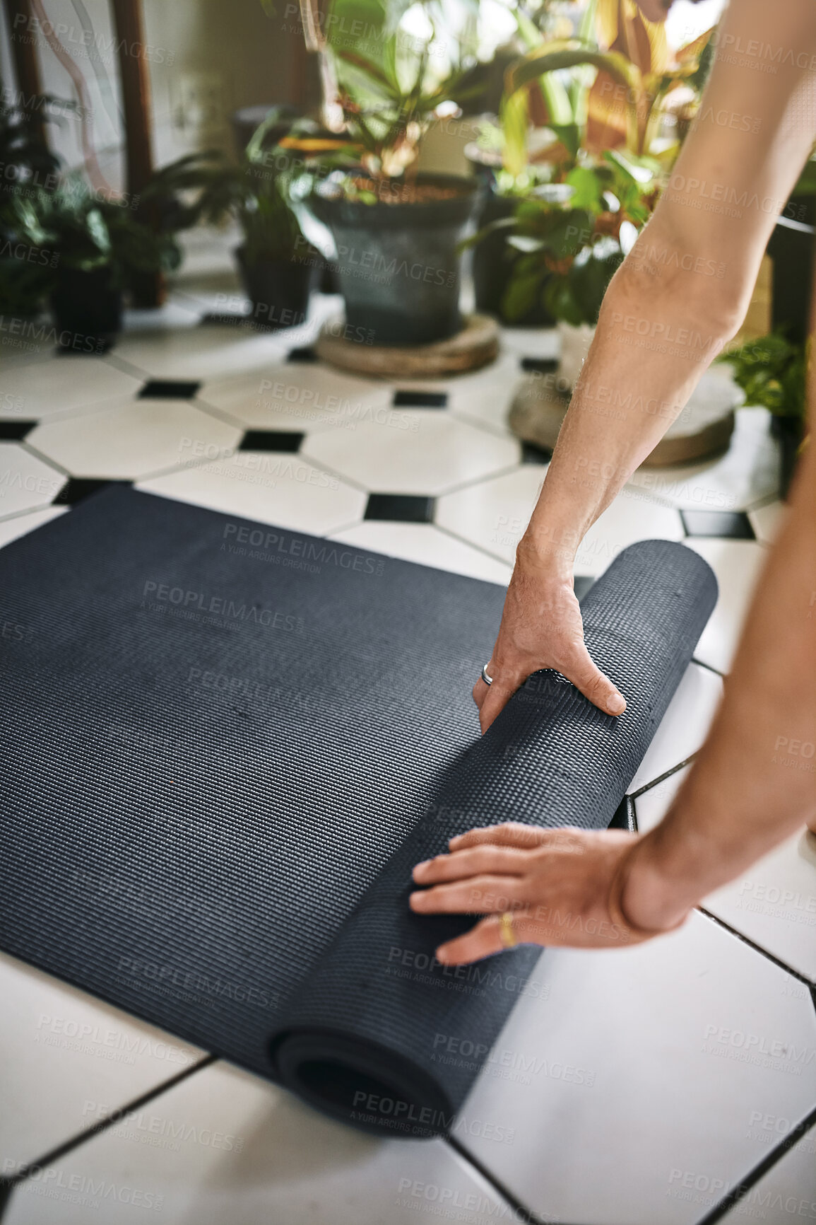Buy stock photo Man, hands and rolling pilates mat in home, prepare equipment and ready for spiritual fitness. Person, practice routine and living room floor for meditation exercise, yoga and start in apartment