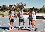 Basketball player, fist bump and friends celebration for training goal, game achievement or teamwork success at outdoor court in urban city park. Group of people or men celebrate on basketball court