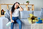 Tired woman, housekeeper and detergent on sofa in the living room for cleaning, hygiene or disinfection at home. Exhausted female maid or cleaner in burnout, stress or fatigue for routine maintenance