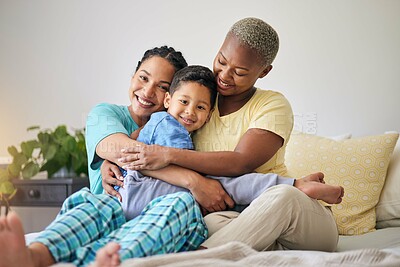 Buy stock photo LGBT, bedroom hug and family portrait, happy child and mothers bond, relax and enjoy time together. Home, bed and gay people, queer parents or lesbian women support, care and hugging adoption kid