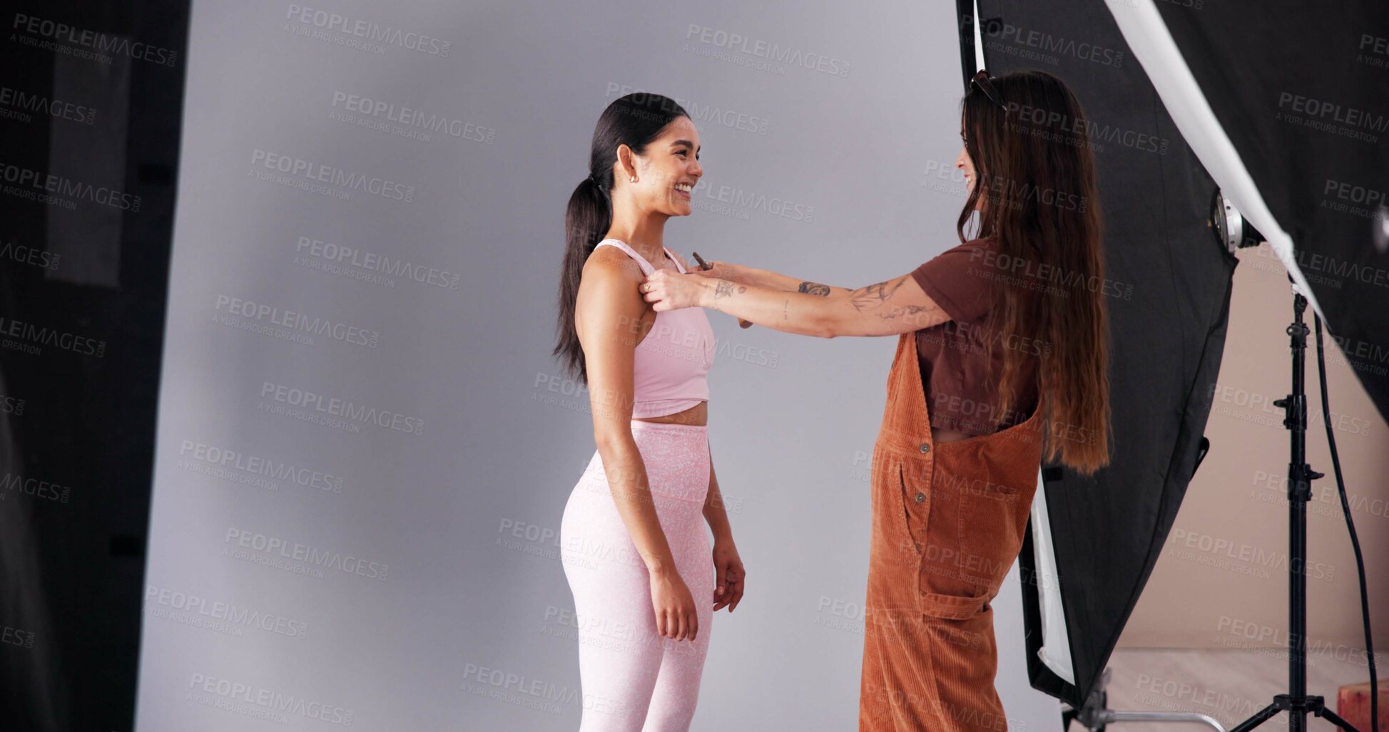 Buy stock photo Photography, art director and model with women in studio for branding campaign, athleisure fashion line or promotion. Behind the scenes, ecommerce photoshoot or media launch with people on set