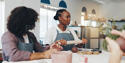 Buy stock photo Woman, pottery workshop and teaching people in class, artistic crafts and rolling pin for molding. Shape, clay sculpture and ceramic learning with instructor, training students and group for lesson