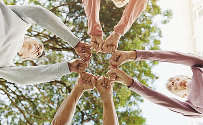 Buy stock photo Outdoor, senior people and fist with huddle for fitness, support and celebration together by below. Nature, retirement and friends with hands for solidarity, exercise goal or motivation by low angle
