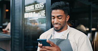 Buy stock photo Man, waiter and outdoor cafe with phone, social media break and communication at coffee shop. Texting, hospitality service and male person online by restaurant front door, reading message and chat
