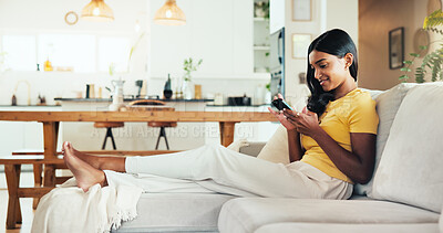 Buy stock photo Relax, phone and smile with woman on sofa for social media post, streaming and network platform. Chat, notification and mobile app with person in living room of home for comment and story update