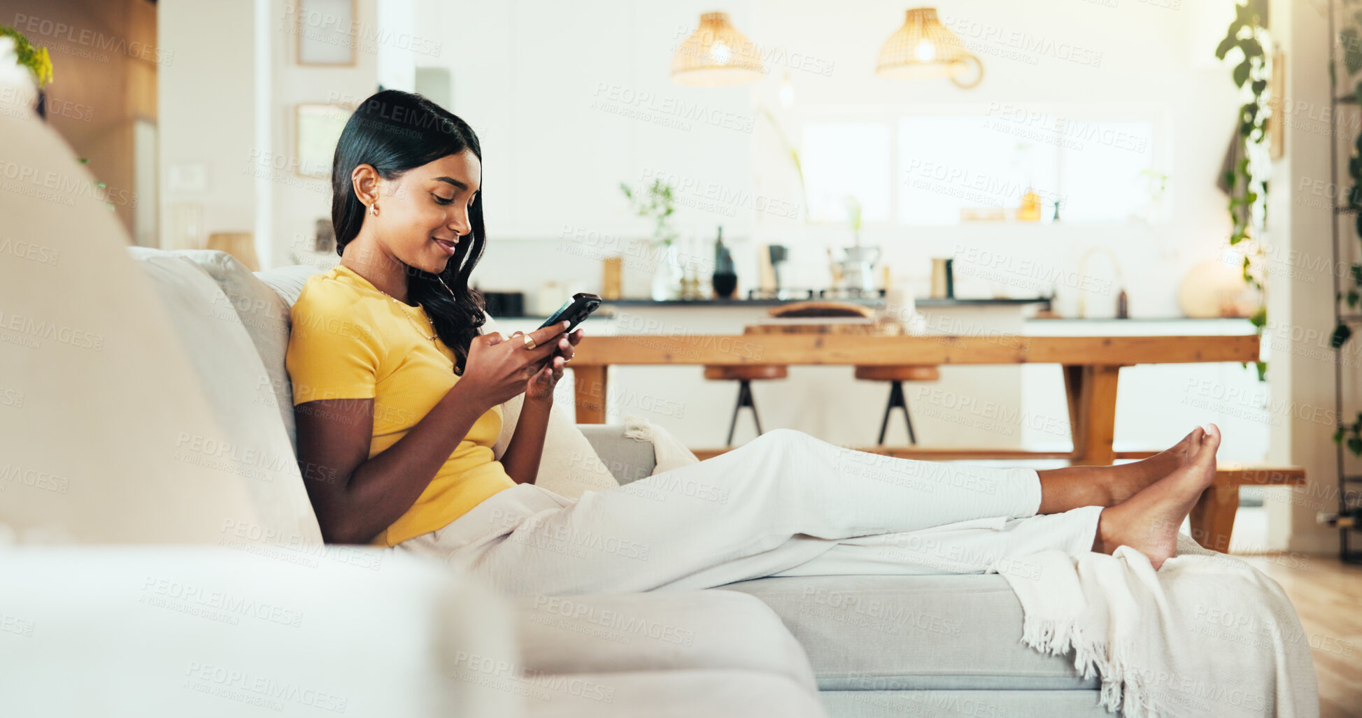Buy stock photo Relax, phone and reading with woman on sofa for social media post, streaming and network platform. Chat, notification and mobile app with person in living room of home for comment and story update