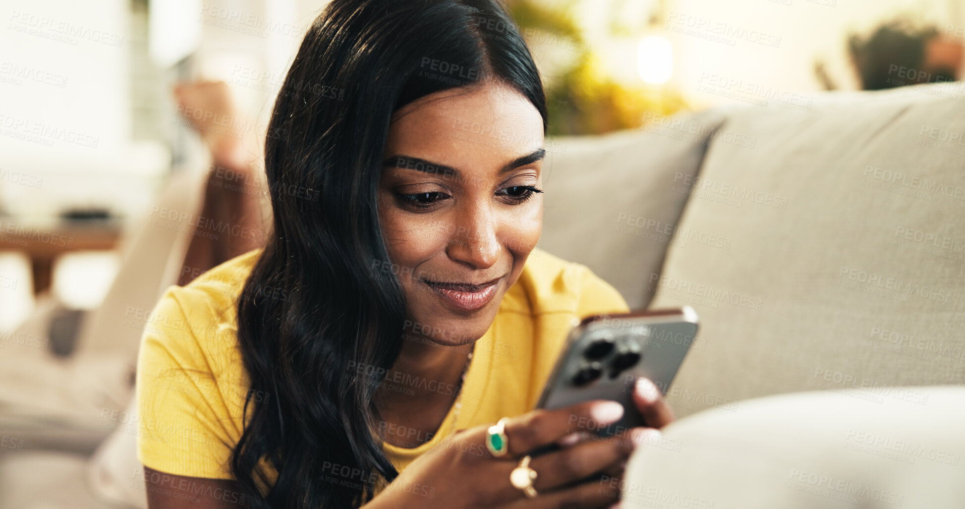 Buy stock photo Relax, browsing and woman with smartphone, home and smile for romance ebook, online and comfortable. Lounge, resting and entertainment for person with mobile, website and reading of novel in house