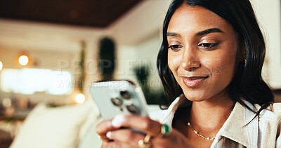 Buy stock photo Woman, phone and texting on couch in home, chat and search for valentines day date in lounge. Girl, person and smile with mobile app, typing and check notification on social network at apartment