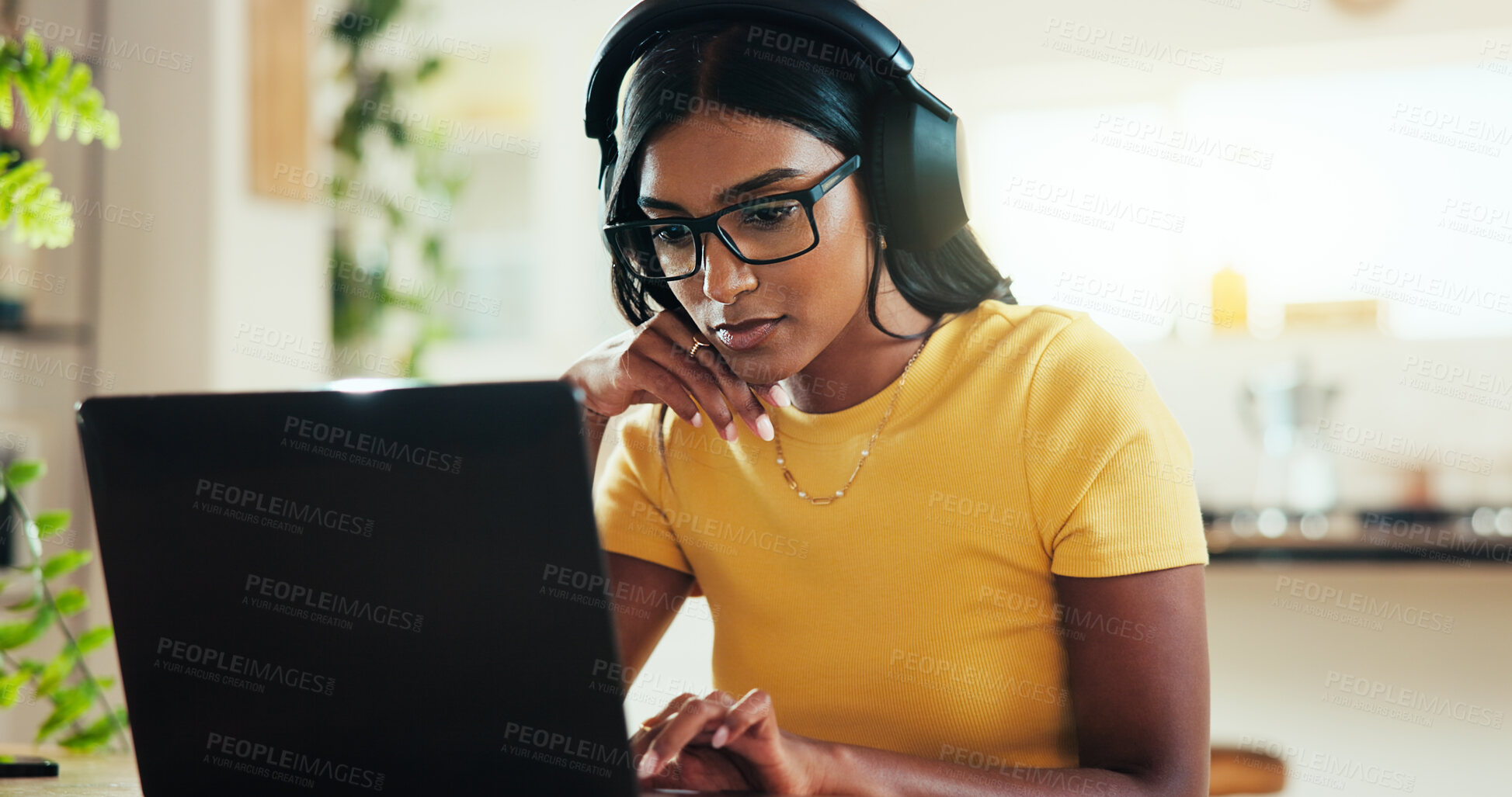 Buy stock photo Laptop, music and remote work with woman in home office as graphic designer for marketing campaign. Computer, headphones and illustration with freelance Indian employee in apartment for publication