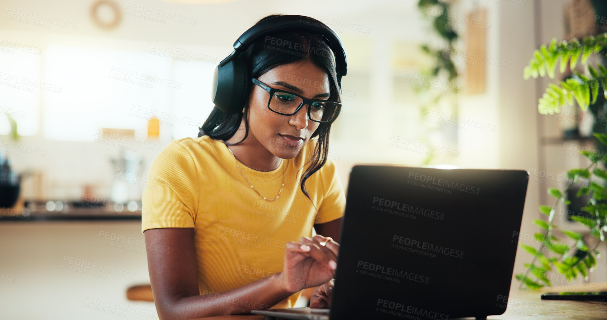 Buy stock photo Laptop, music and thinking with Indian woman in home office as graphic designer for marketing campaign. Computer, headphones and remote work with freelance employee in apartment for publication