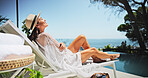 Woman, sunbathing and smile with vacation, rest and relax for trip, break and travel. Luxury resort, peace and girl with deck chair, adventure and carefree for hotel accommodation or hospitality